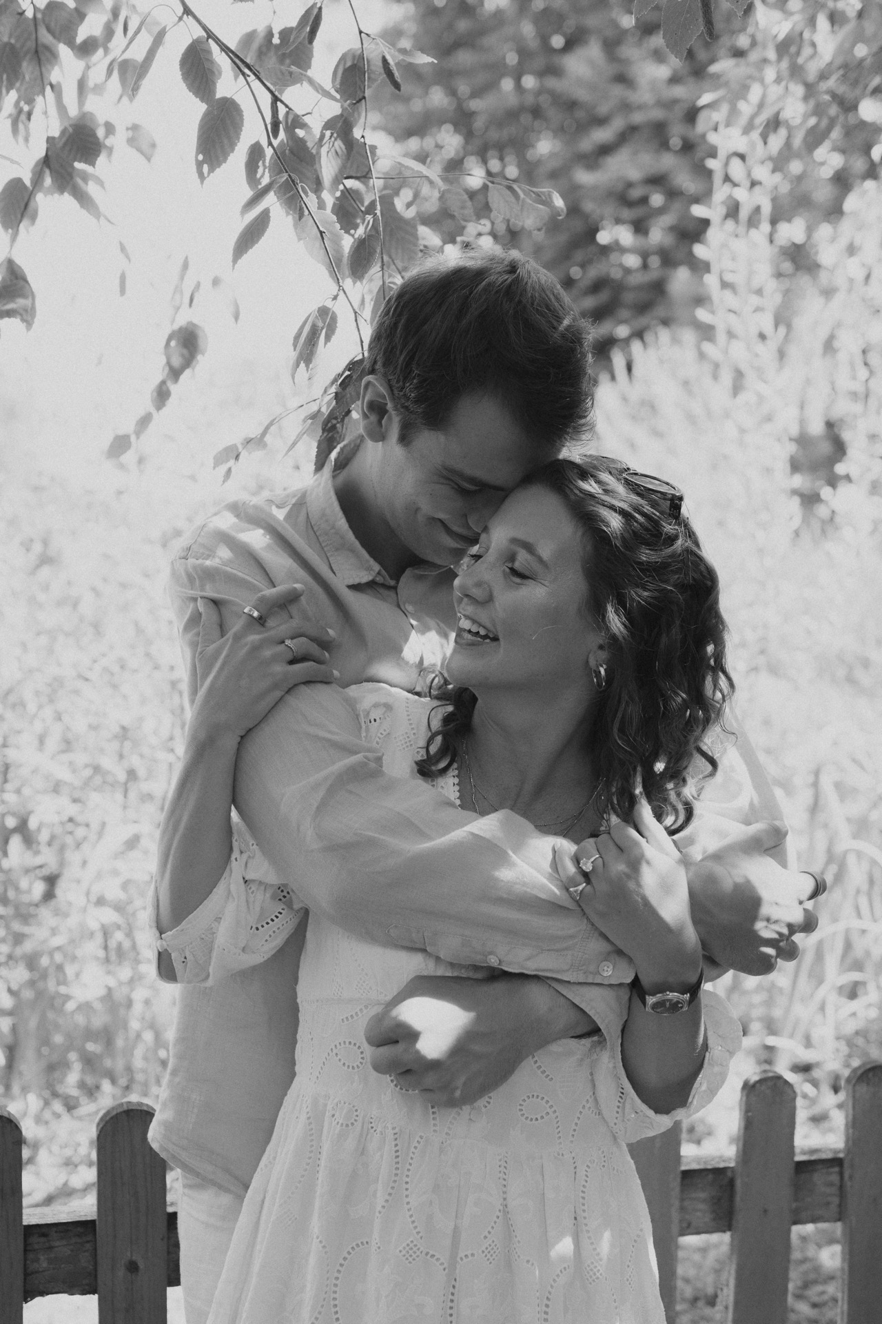 Vere with his arms around Ella in the garden, in black and white